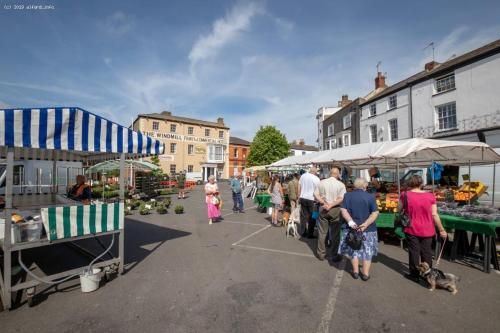 a group of people walking around an outdoor market at The Windmill Hotel in Lincolnshire