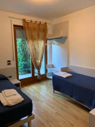 En eller flere senge i et værelse på Appartamento Ivonn con giardino