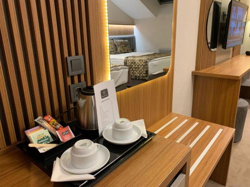 a hotel room with a tray with dishes on it at Özkaya hotel in Sivas