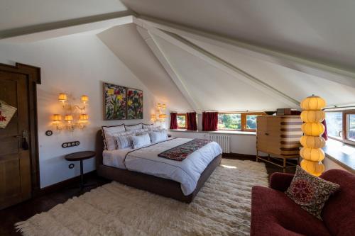 a bedroom with a bed and a chair in a room at Casa Beatnik Hotel in Santiago de Compostela