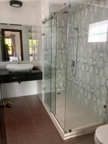 a bathroom with a shower and a sink at Lily Pad Boutique Hotel in Siem Reap