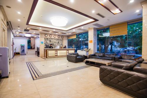 a lobby with leather couches and a salon at Western Hanoi Hotel in Hanoi