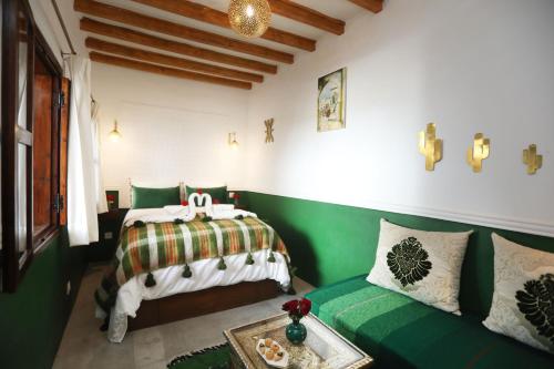 馬拉喀什的住宿－Riad Heklek，一间卧室配有一张床和一张沙发