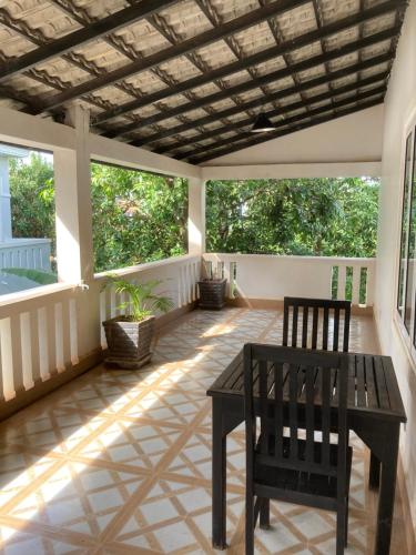 a screened in porch with a table and chairs at Lily Pad Boutique Hotel in Siem Reap