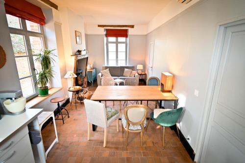 a living room with a wooden table and chairs at Gîte de Montfranc in Pierrefitte-sur-Sauldre