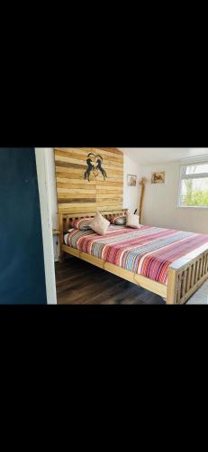 a bedroom with a large bed with a wooden headboard at The stables 