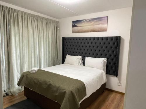 1 dormitorio con cama y ventana grande en luxury with power backup, en Johannesburgo