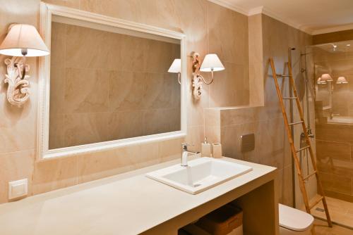 吉雄的住宿－EFMAR EXCLUSIVE RESIDENCES，一间带水槽、镜子和淋浴的浴室