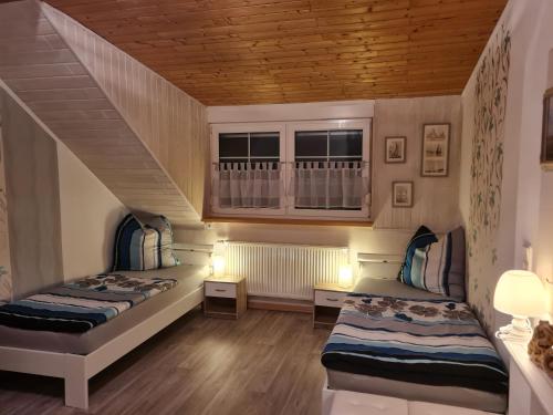 two beds in a room with a staircase at Ferienwohnung Elbblick in Dessau