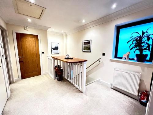 a living room with a large screen tv on a wall at Modern and cozy 2-guest flat with gated parking in Kingston upon Thames