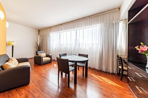 a living room with a table and a couch at Suites Teca Once in Mexico City
