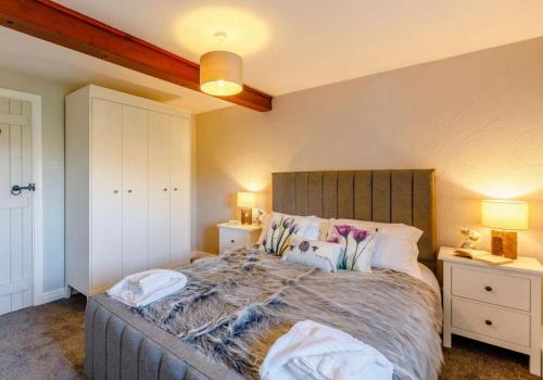 a bedroom with a large bed and two night stands at Troutbeck Inn in Troutbeck