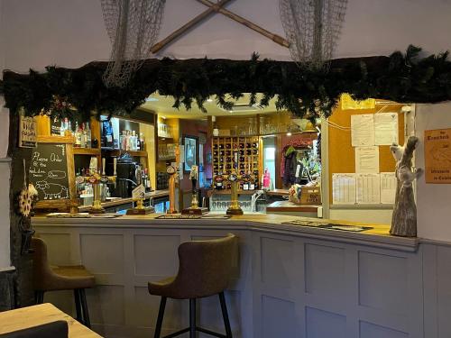 a bar in a restaurant with two stools at Troutbeck Inn in Troutbeck