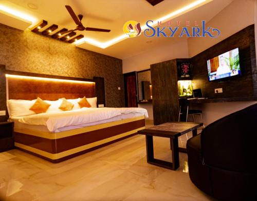 a hotel room with a bed and a tv at Hotel Skyark in Kanyakumari
