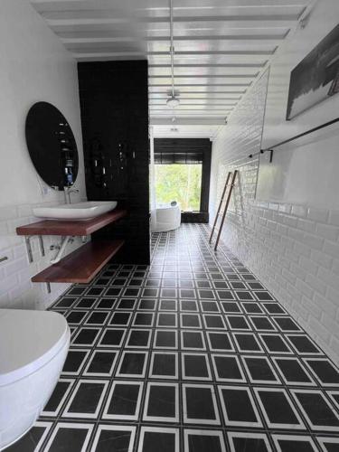 a bathroom with a black and white tiled floor at The Black Box Villa - Genting Highland Foot Area in Bentong