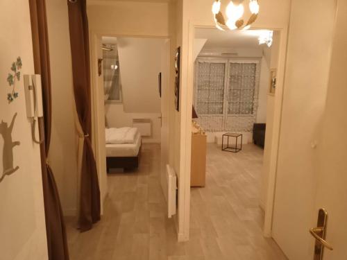 a hallway leading to a room with a bedroom at Cap des pins in Quend