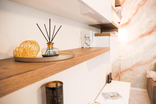 a room with a shelf with some plants on it at Fall In Love with Como Lake in Bellano