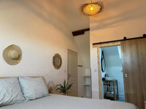 a bedroom with a bed and a mirror on the wall at Chambres d'Hôtes Maison Balady in Bellenaves