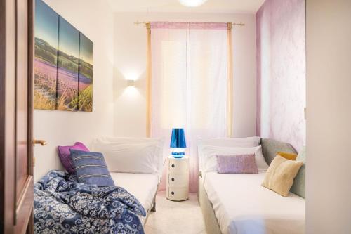 a bedroom with two beds and a window at Fall In Love with Como Lake in Bellano