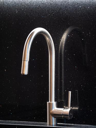 a stainless steel sink with a chrome faucet at Fall In Love with Como Lake in Bellano