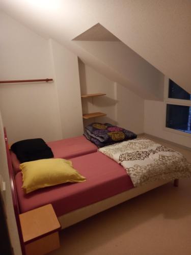 a small bedroom with a bed with a stair hesitate at T3 duplex village geolia Saint geniez d'olt avec 2 piscines aux portes de l'aubrac 64 in Saint-Geniez-dʼOlt