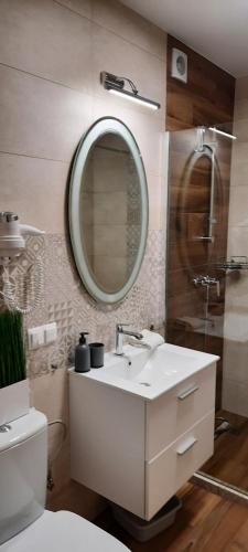 a bathroom with a sink and a mirror at Apartamenty U Piotra in Czarny Dunajec