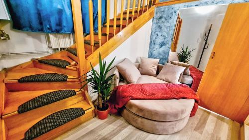 a living room with a couch and a staircase at Royal mansion in Unirii Square in Cluj-Napoca