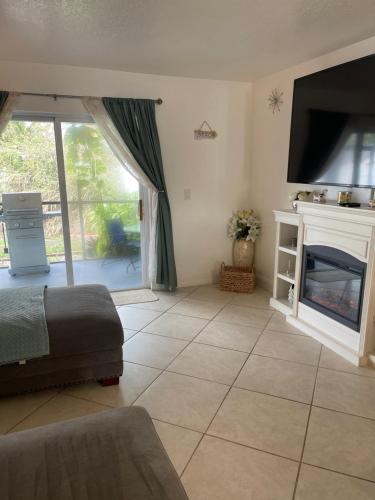 a bedroom with a bed and a fireplace and a tv at Bright and Beachy 2Bed 1Bath Home - Unit 210 in Cocoa Beach