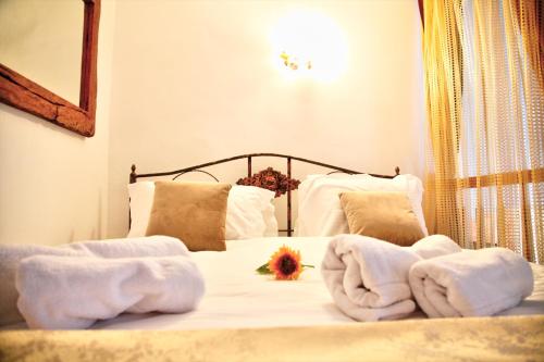 a bedroom with a bed with towels on it at Royal mansion in Unirii Square in Cluj-Napoca