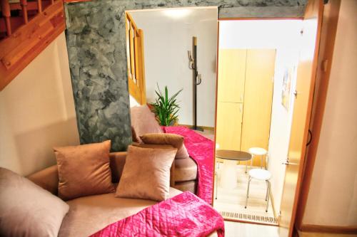 a living room with a couch and a mirror at Royal mansion in Unirii Square in Cluj-Napoca