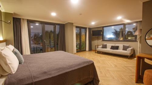 a bedroom with a bed and a living room with a couch at Istanbul Old City Colorful Houses Balat PETRION Hotel in Istanbul