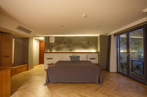 a bedroom with a bed and a large window at Istanbul Old City Colorful Houses Balat PETRION Hotel in Istanbul