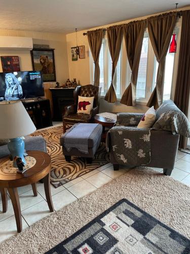 a living room with a couch and chairs and a television at Blue Knob Bear Den (Nordic Center/Golf Course) in Claysburg