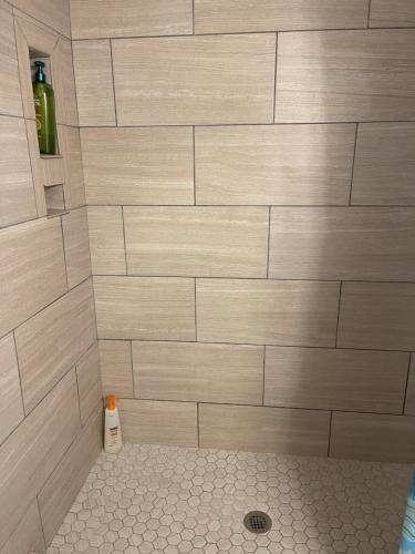 a bathroom with a shower with a large tile wall at Beautiful Bright & Sparkling 2Bed 1Bath Beach Retreat - Unit 212 in Cocoa Beach