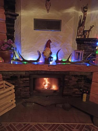 a fireplace with antlers and christmas lights on it at Górski Wypoczynek in Stryszawa
