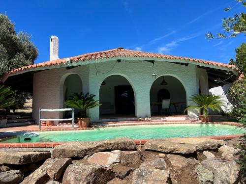 a house with a swimming pool in front of it at Casale al mare - villa with swimming pool 150 meters from the beach in Porto Columbu - Perdʼe Sali