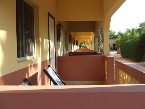 a balcony of a house with a view of a garden at The Gunjur Project Lodge in Gunjur