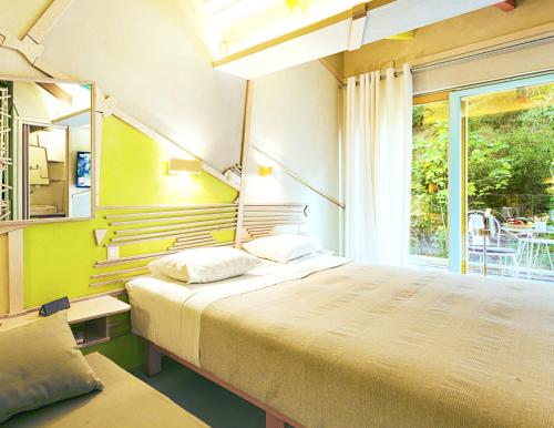 a bedroom with a large bed and a window at Villa Rossa in Parga