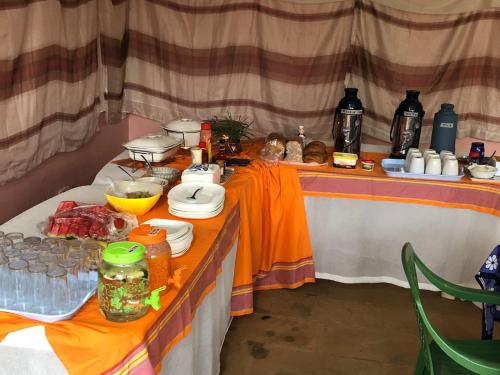 a table with food and drinks on it at Edaala Comfort - Cottage Rooms in Nairobi