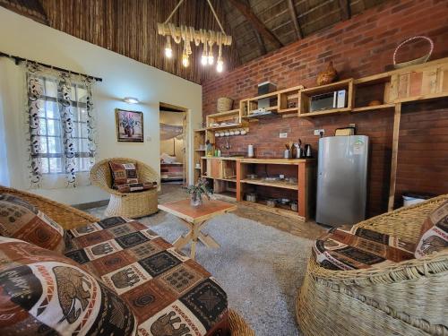 a living room with two couches and a refrigerator at Edaala Comfort - Cottage Rooms in Nairobi
