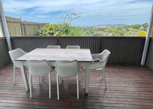 a white table and chairs on a deck at The Gregory in Pinetown