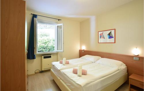 a bedroom with a large bed with two candles on it at Casa Vacanza Sole in Tremosine Sul Garda