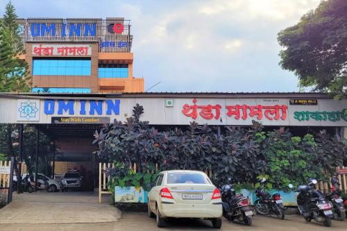 a car parked in front of a building at Hotel Om Inn - Talegaon Dabhade in Talegaon Dābhāde