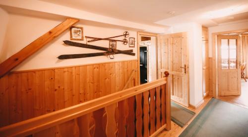 a room with a staircase with skis on the wall at Posers Bergwelt B&B in Schladming