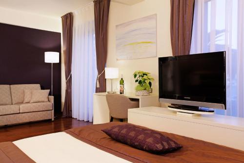 a living room with a large flat screen tv at Hotel Korkyra in Vela Luka