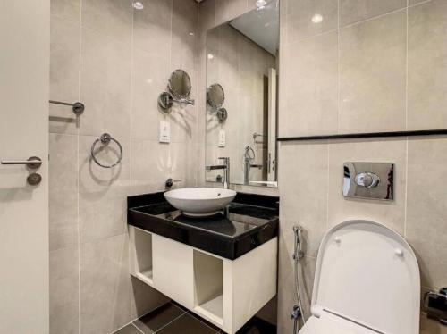 a bathroom with a sink and a toilet at Brand New Studio in Artesia in Damac Hills in Dubai