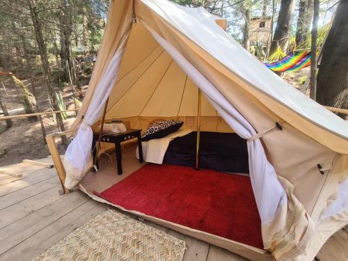 a tent on a wooden deck with a bed in it at xiquipilli glamping (jiquiterra) 