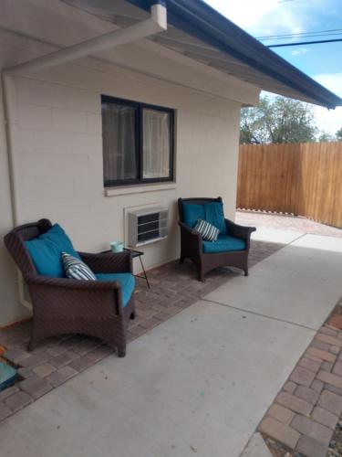 a patio with two chairs and a fireplace at Red Rock Motel and Dam Motel in Page