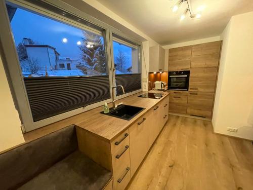 a kitchen with a sink and a large window at Wonder & Wander in Ehrwald