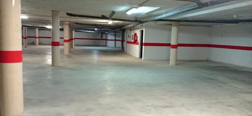 an empty parking garage with a red stripe on the wall at Apartamento14 Ruidera AguaPlacer in Ruidera